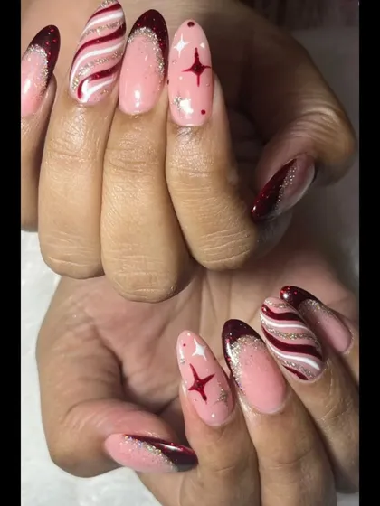 All you want for Christmas is perfectly polished nails. This intricate design features candy cane swirls, stars, and a sparkling glitter gradient for a truly festive look.