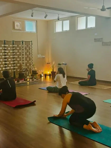 A class begins with a centering meditation, with the shala's altar in the background, creating a sacred and peaceful atmosphere for our practice.