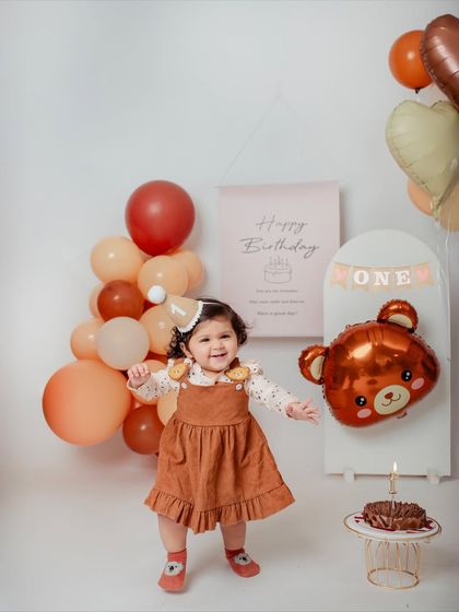 Look who's walking. This little girl just started walking right before her first birthday, and we captured her wobbly first steps during her teddy bear themed shoot.