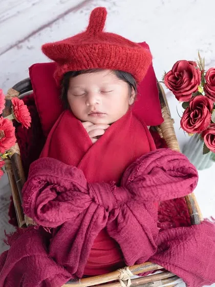 A beautiful, classic newborn portrait in a rich red color scheme.