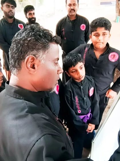 I am explaining concepts to a group of young students. Teaching and mentoring the next generation is a vital part of my role.