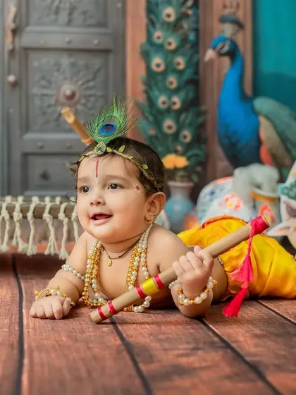 A happy crawling Krishna, looking up with a sweet smile.