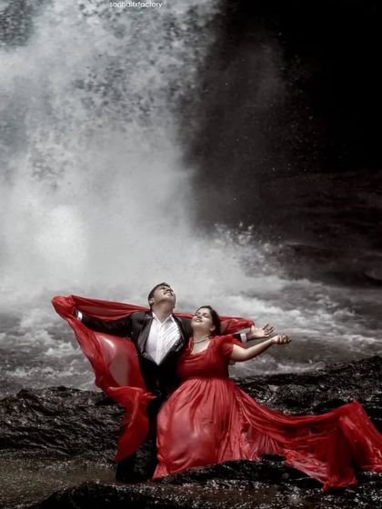 For the adventurous couple, a photoshoot by a waterfall makes for unforgettable pictures. This maroon flying gown and matching black blazer are durable enough for outdoor locations while still looking dramatic.