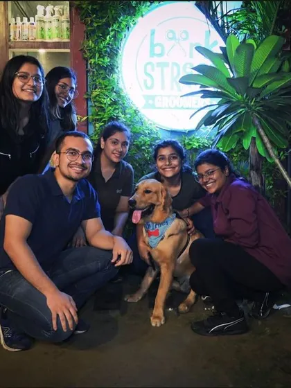 Our cafe is bustling with joy! This group photo was taken during one of our lively nights with music, celebrations, and lots of happy faces, both human and canine.