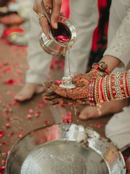 The Kanyadaan, a deeply symbolic and emotional ritual. This close-up on the couple's hands during the ceremony highlights the tradition and the textures of henna and holy water, telling a story of heritage and commitment.