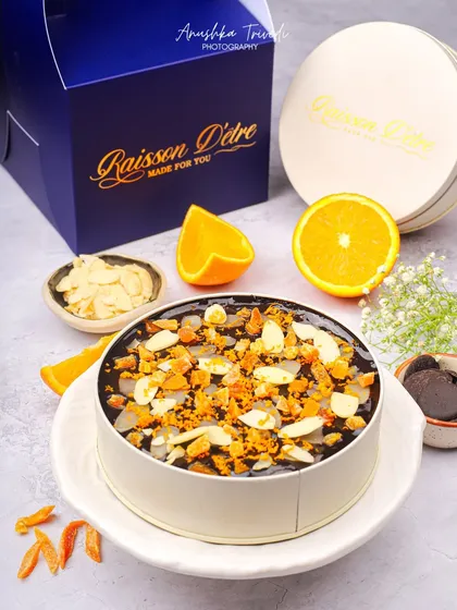 A stunning orange and chocolate almond cake. The bright, fresh orange slices and clean packaging make this a perfect shot for a product catalogue.