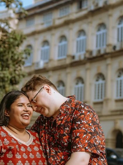 An image capturing the genuine smiles and affection between a couple, with the urban environment adding context to their story.