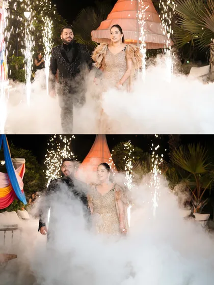 A dramatic entrance for the couple at their outdoor Sangeet, walking through a cloud of smoke and surrounded by cold pyro fireworks.