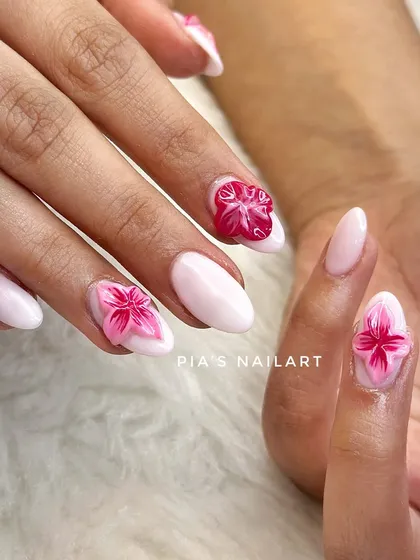 Trending 3D jelly flowers on a milky white base. These flowers are encapsulated within the nail, giving them a unique, translucent effect that is super popular right now.