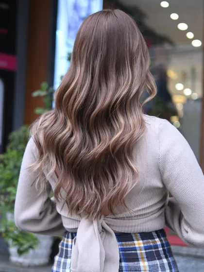A closer look at the artistry of a well-executed balayage. You can see the delicate blend of ash blonde and light brown tones, creating a soft, natural gradient that looks beautiful from every angle. This is a perfect example of a low maintenance hair color style.