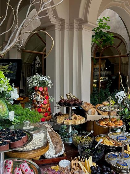 The beautiful chaos of an abundant grazing table, set against the elegant architecture of the venue.