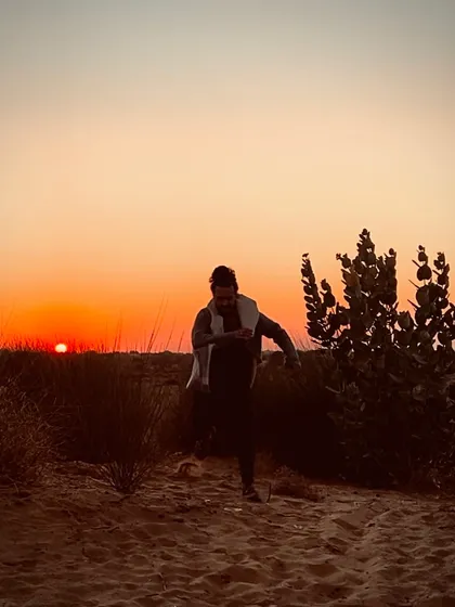 A candid shot of me running through the sand dunes of Rajasthan at sunset.