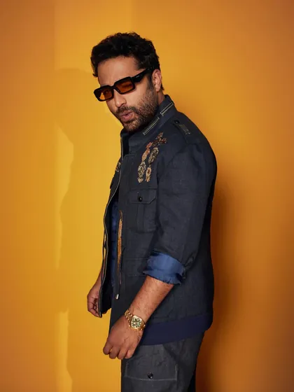 Vishwak Sen in a striped blue flannel wool jacket. This piece blends comfort and style, featuring a collared design with printed metal accents for a touch of industrial elegance.