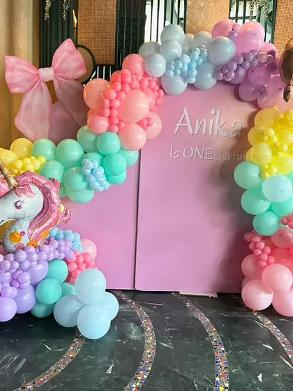 A 'ONE-derful' first birthday filled with unicorn magic. This vibrant pastel rainbow balloon arch, complete with a unicorn and ice cream cone accents, creates a playful and dreamy backdrop for a little one's special day.