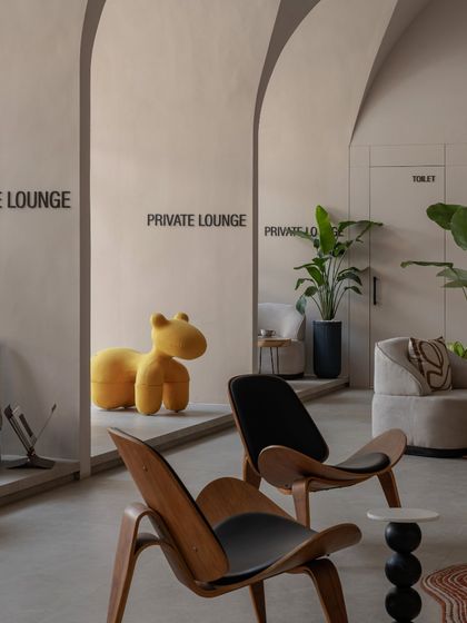 Detail of the private lounge entrances. The simple, clean typography and the playful pop of the yellow seat create a unique blend of business sophistication and creative design.
