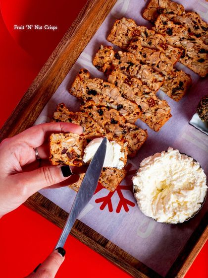 A festive spread featuring our Fruit 'N' Nut Crisps, a perfect addition to any holiday gathering.