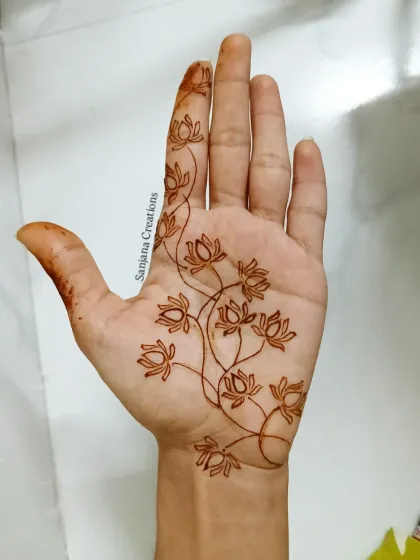 The first step of the lotus vine design. This shows the clean, confident outline that forms the base of the artwork.