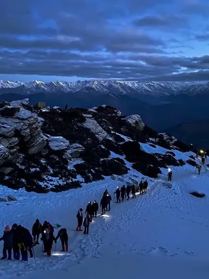 The midnight push on the Brahmatal trek. A line of headlamps snakes its way up the snowy slope towards the summit.