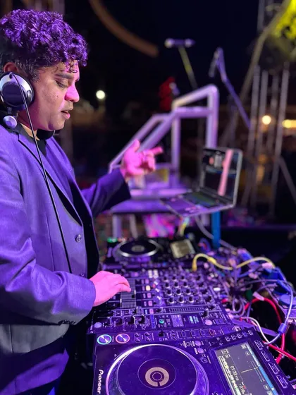 In action at a DJ night, pointing to the beat. Every event is a new opportunity to create a unique live performance and connect with the audience.