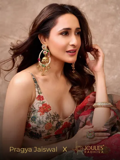 A beautiful portrait of Pragya Jaiswal, where the statement earrings, kadas, and ring come together to create a look of festive perfection.