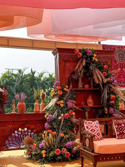 The complete seating arrangement under a canopy of draped fabric, looking out onto the sunny venue, blending comfort with thematic elegance.