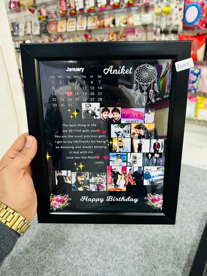 Holding the finished birthday frame, you can see the depth of the box frame and the clear, matte-laminated finish that protects the print.