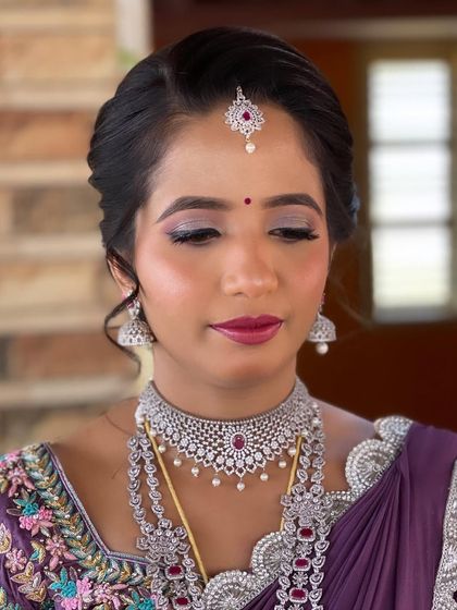 A close-up of the eye makeup, showing the delicate blend of colors and the precise application that defines the look.