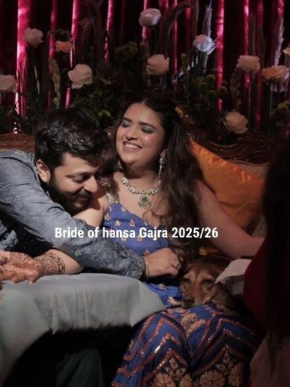 Laughter and love fill the air at this mehendi ceremony. The bride shares a happy moment with her partner, her hands beautifully adorned with fresh henna.