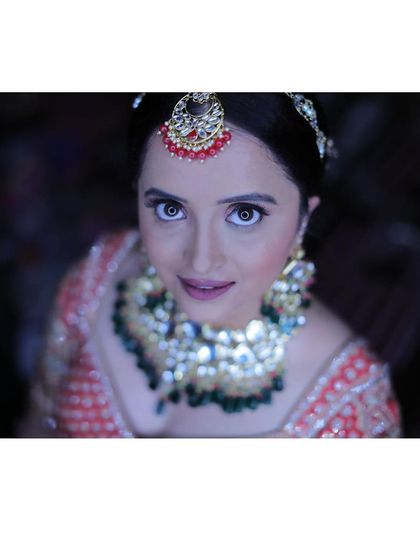 For this North Indian reception look, we went for full glam. I created a soft, shimmery pink eyeshadow look and sculpted her features to catch the light beautifully, making her eyes the star of the show.