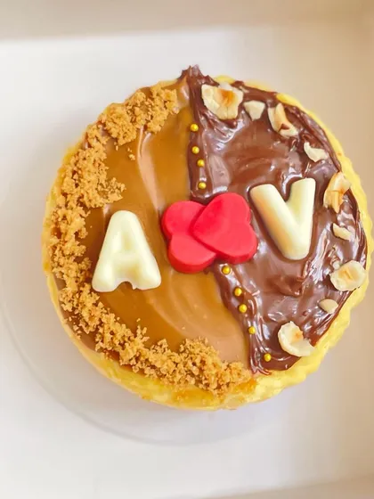 Celebrating love with a personalized touch. This eggless New York Baked Cheesecake is customized with the couple's initials, making it a perfect anniversary or engagement dessert.