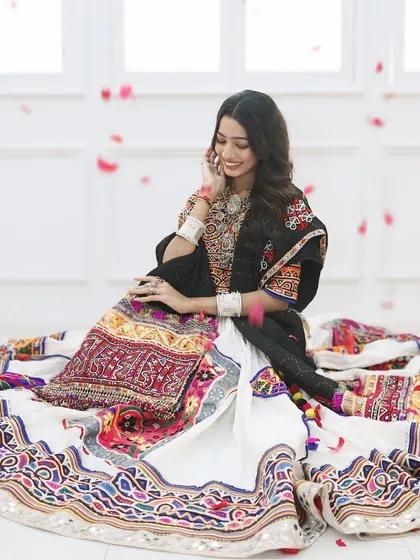 Surrounded by a shower of petals, this Navratri look is pure magic. The traditional outfit and jewelry are the stars, so we kept the makeup fresh and glowing.