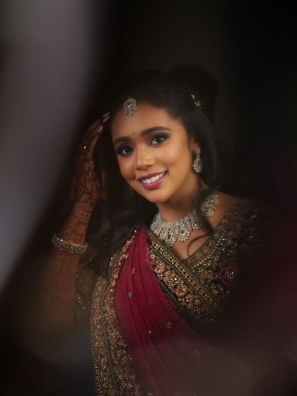 An artistic shot of Dr. Saruna, capturing her radiant smile. The lighting and composition create a beautiful and memorable portrait.