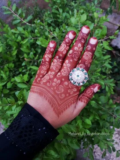 A full view of the hand, showing the delicate floral work perfect for any party.