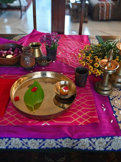 The festive table setting, featuring a two-tone raw silk tablecloth with a brocade border. You can order your own custom festive linens for any season.