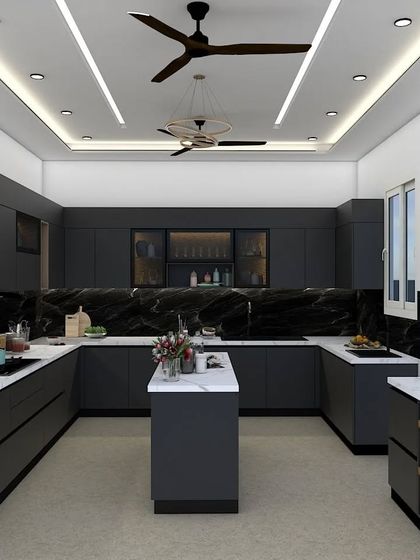 This U-shaped kitchen is a masterclass in modern, moody design. The matte black cabinetry, paired with a striking black marble backsplash and white marble countertops, creates a bold and dramatic statement, perfect for those who love sophisticated interiors.