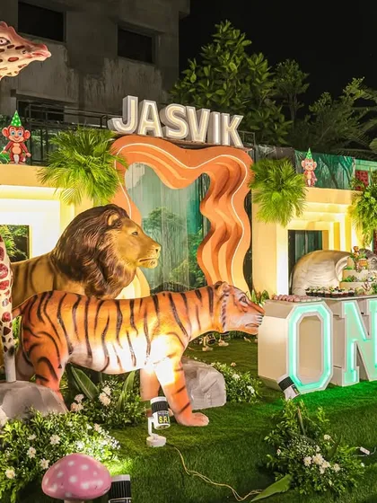 A closer look at the grand outdoor jungle stage, featuring large, illuminated animal props and a custom-built entrance.