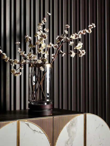 The beauty of my work is often in the details. This close-up shows a custom CNC-cut wall surface that adds tactile depth, paired with a bespoke console featuring Statuario tile and brass metal inlay for a refined finish.