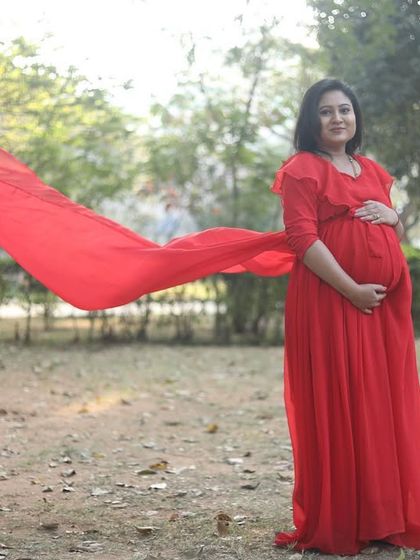 A dramatic shot with a flowing red fabric. The makeup is kept simple to let the vibrant color and the moment shine.