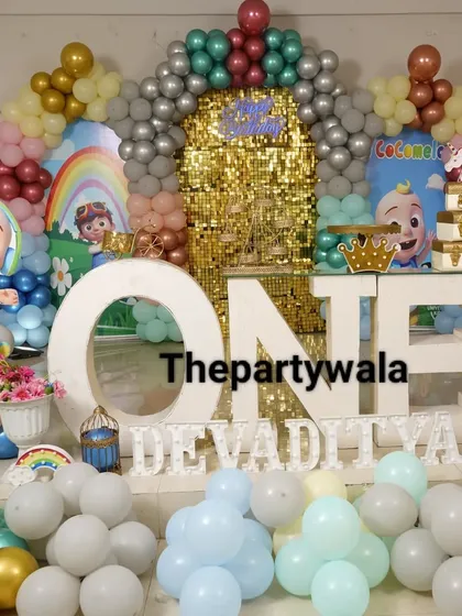 Look at this massive Cocomelon party! I can create a huge stage with a giant "ONE" sign, a golden shimmer wall, and all the Cocomelon characters. It's a bright, colorful, and exciting theme that all the kids will love.