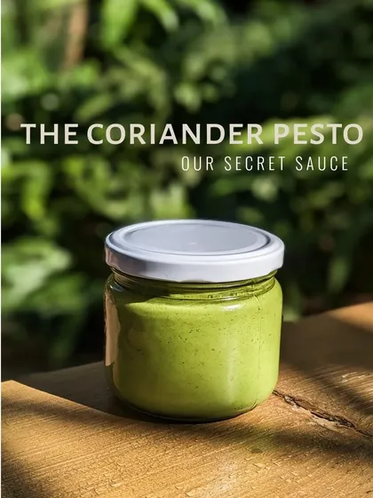 Our secret sauce, the coriander pesto, bottled up and looking vibrant. We make all our sauces and dressings in-house.