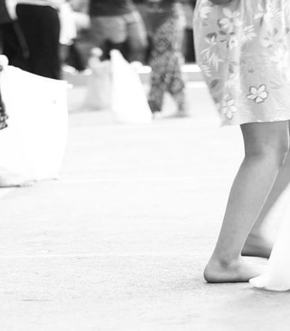 A detail shot from a workshop, focusing on the simple, ghost-like marionettes the children have made. The beauty of puppetry is that even the simplest forms can tell a story.