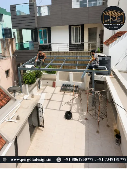 A wider angle of the work in progress. This view shows the scale of the terrace project and how the custom-fabricated pergola structure is designed to fit the specific dimensions of the space.