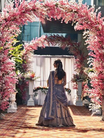 A back view of the mauve-purple lehenga, highlighting the elegant drape of the dupatta.