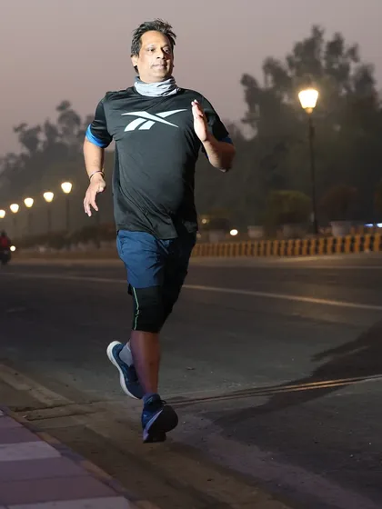An athlete captured in motion during our early morning run. The streetlights create a dramatic effect.
