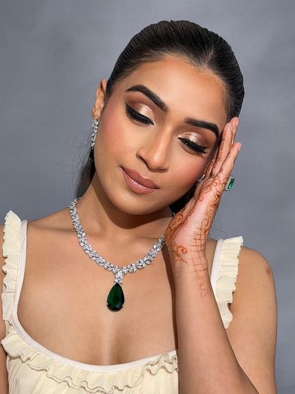 Eyes closed, this shot highlights the beautiful gold shimmer and the precise winged liner taught in my advanced course.