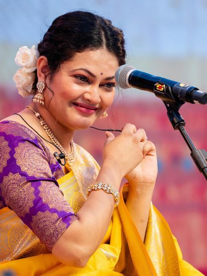 A close-up of Priyanka Barve's happy expression and the intricate details of her traditional jewelry and hair styling.