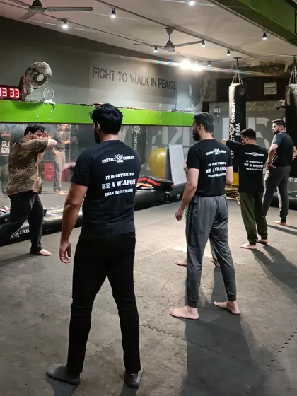 In close quarters, the elbow is one of your most powerful weapons. I am explaining the proper body mechanics for a devastating elbow strike to my students.