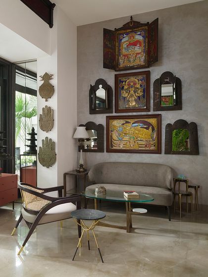 This seating area in the Courtyard Home is a dialogue between different cultures and eras. A contemporary chair from our Koko collection sits beside a rotating Edwardian bookshelf, with a backdrop of traditional Indian art and antique mirrors, showcasing our love for eclectic curation.