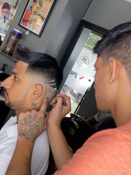 Here I am in the middle of creating a detailed hair design. The process requires concentration to get every line perfect.