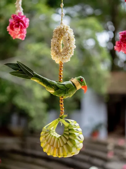 It's the small, thoughtful details that make a wedding truly unique. This charming parrot, intricately crafted from palm leaves, is an example of the bespoke, traditional elements I incorporate to add a touch of artistry and symbolism to your decor.